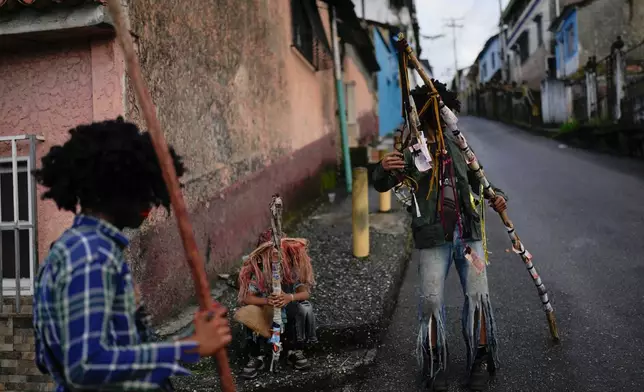 Revelers take part in the centuries-old Afro-Venezuelan Holy Innocents celebration in Caucagua, Venezuela, Sunday, Dec. 28, 2025. (AP Photo/Matias Delacroix)