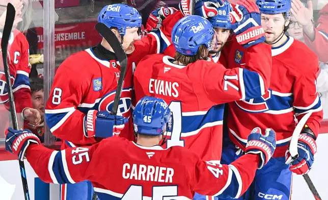 Montreal Canadiens' Joseph Veleno (90) celebrates with teammates Mike Matheson (8), Alexandre Carrier (45), Jake Evans (71) and Josh Anderson (17) after scoring against the Edmonton Oilers during second-period NHL hockey game action in Montreal, Sunday, Dec. 14, 2025. (Graham Hughes/The Canadian Press via AP)