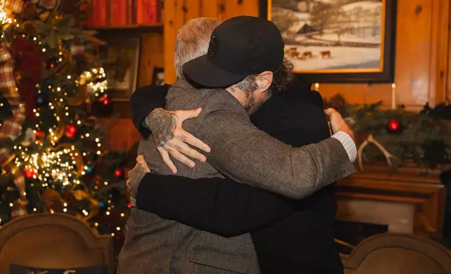 This photo provided by the office of Tennessee Gov. Bill Lee shows Gov. Bill Lee, left, hugs country musician Jelly Roll on Thursday, Dec. 18, 2025, at the Tennessee Governor's Mansion in Oak Hill, Tenn. (Brandon Hull/Office of Gov. Bill Lee via AP)