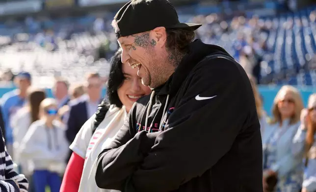 FILE - Entertainer Jelly Roll talks on the sidelines before an NFL football game between the Titans and the Seattle Seahawks, Nov. 23, 2025, in Nashville, Tenn. (AP Photo/George Walker IV, File)