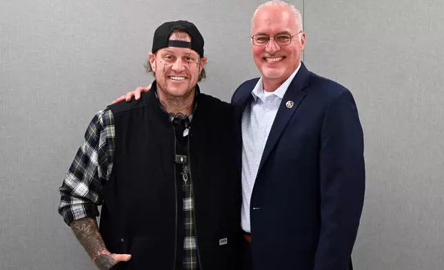 This photo provided by the Nashville-Davidson County Sheriff's Office shows country music star Jelly Roll, left, whose legal name is Jason DeFord, posing for a photo with Davidson County Sheriff Daron Hall at the Davidson County Sheriff’s Office Annex in Nashville, Tenn., Nov. 25, 2025. (Reginald Scott/Nashville-Davidson County Sheriff's Office via AP)