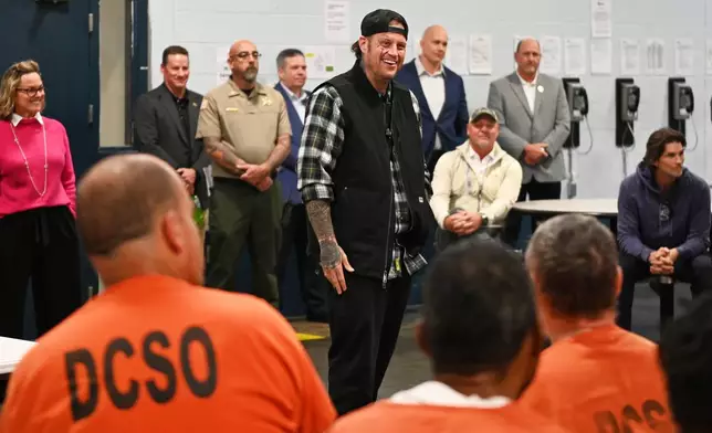 This photo provided by the Nashville-Davidson County Sheriff's Office shows country music star Jelly Roll, whose legal name is Jason DeFord, speaking to inmates at the Davidson County Sheriff’s Office Annex in Nashville, Tenn., Nov. 25, 2025. (Reginald Scott/Nashville-Davidson County Sheriff's Office via AP)