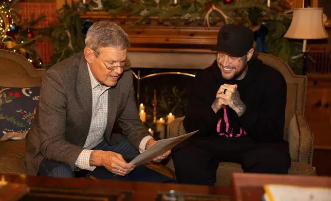 This photo provided by the office of Tennessee Gov. Bill Lee shows Gov. Bill Lee, left, giving country musician Jelly Roll news of his official pardon Thursday, Dec. 18, 2025, at the Tennessee Governor's Mansion in Oak Hill, Tenn. (Brandon Hull/Office of Gov. Bill Lee via AP)