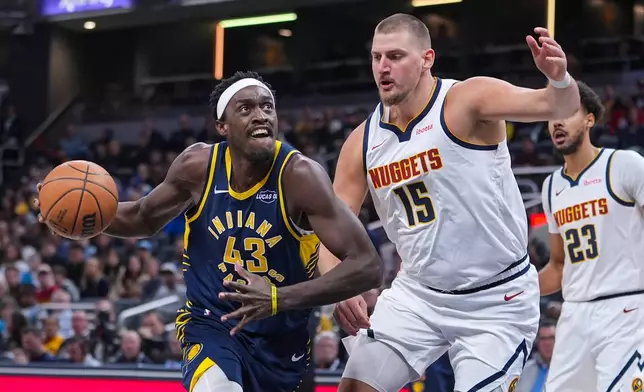 Indiana Pacers forward Pascal Siakam (43) looks to shoot over Denver Nuggets center Nikola Jokic (15) during the first half of an NBA basketball game in Indianapolis, Wednesday, Dec. 3, 2025. (AP Photo/Michael Conroy)
