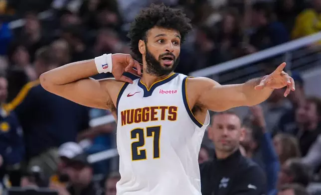 Denver Nuggets guard Jamal Murray (27) reacts after scoring his 50th point against the Indiana Pacers during the second half of an NBA basketball game in Indianapolis, Wednesday, Dec. 3, 2025. (AP Photo/Michael Conroy)