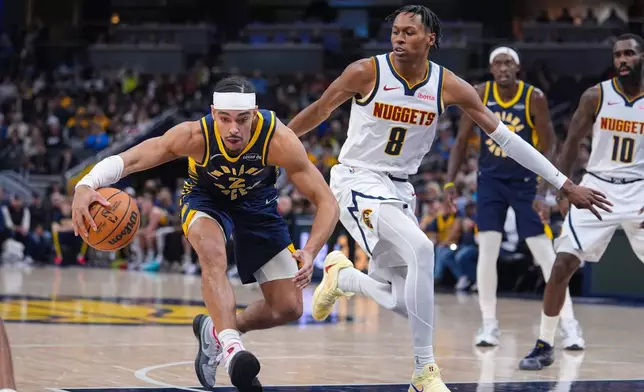 Indiana Pacers guard Andrew Nembhard (2) drives past Denver Nuggets guard Peyton Watson (8) during the first half of an NBA basketball game in Indianapolis, Wednesday, Dec. 3, 2025. (AP Photo/Michael Conroy)
