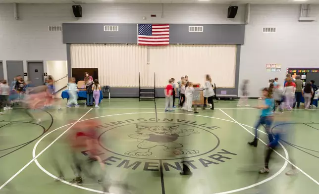 Students rotate stations during a science, technology, engineering and mathematics activity, facilitated by the Kentucky Science Center, in Simpsonville Elementary School, Nov. 18, 2025, in Simpsonville, Ky. (AP Photo/Jon Cherry)