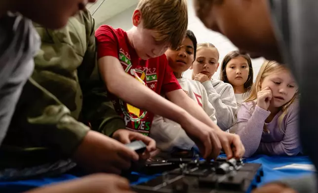 Students work together on a science, technology, engineering and mathematics challenge, facilitated by the Kentucky Science Center, in Simpsonville Elementary School, Nov. 18, 2025, in Simpsonville, Ky. (AP Photo/Jon Cherry)