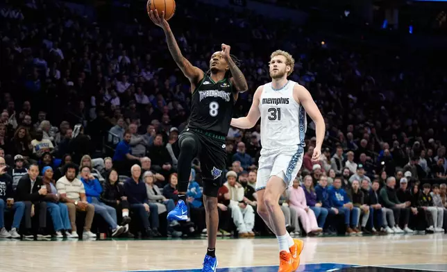 Minnesota Timberwolves guard Bones Hyland (8) goes up for a shot as Memphis Grizzlies center Jock Landale (31) follows during the first half of an NBA basketball game, Wednesday, Dec. 17, 2025, in Minneapolis. (AP Photo/Abbie Parr)