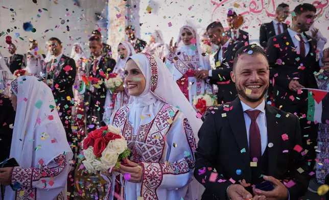 Palestinian couples participate in a mass wedding ceremony in Hamad City in Khan Younis, Gaza Strip, Tuesday, Dec. 2, 2025. (AP Photo/Abdel Kareem Hana)