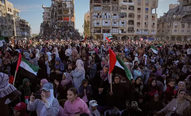 Palestinian watch and celebrate a mass wedding ceremony in Hamad City in Khan Younis, Gaza Strip, Tuesday, Dec. 2, 2025. (AP Photo/Abdel Kareem Hana)