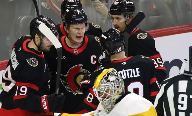 Ottawa Senators' Brady Tkachuk, center, celebrates his goal with teammates during the first period of an NHL hockey game against the Pittsburgh Penguins in Ottawa, Ontario, Thursday, Dec. 18, 2025. (Patrick Doyle/The Canadian Press via AP)