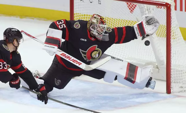 Ottawa Senators goaltender Linus Ullmark (35) reaches for the puck during the first period of an NHL hockey game in Ottawa, Ontario, Thursday, Dec. 18, 2025. (Patrick Doyle/The Canadian Press via AP)