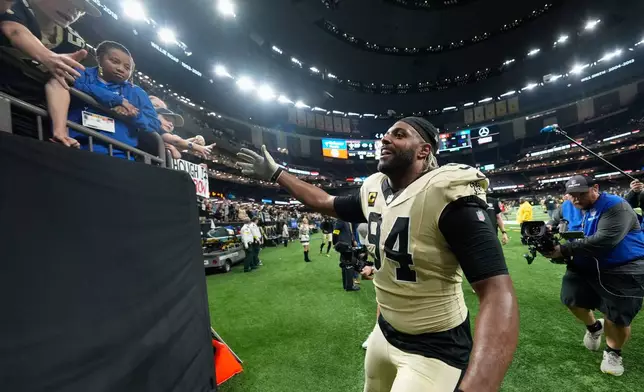 New Orleans Saints defensive end Cameron Jordan greets fans after an NFL football game against the New York Jets, Sunday, Dec. 21, 2025, in New Orleans. (AP Photo/Gerald Herbert)