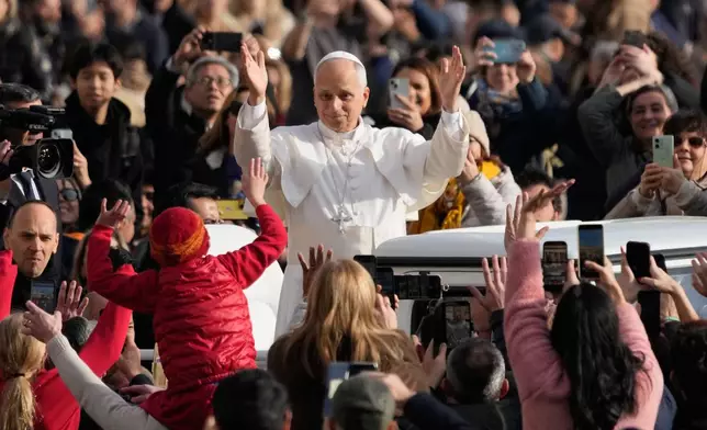 Pope Leo XIV waves to faithful as he arrives in St. Peter's Square on the occasion of the last Jubilee audience, at the Vatican, Saturday, Dec. 20, 2025. (AP Photo/Gregorio Borgia)