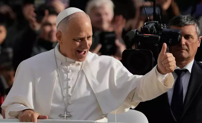 Pope Leo XIV greets faithful as he arrives in St. Peter's Square on the occasion of the last Jubilee audience, at the Vatican, Saturday, Dec. 20, 2025. (AP Photo/Gregorio Borgia)