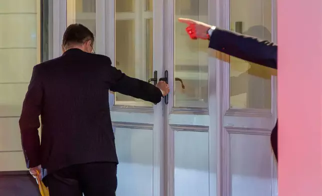 Belgian Prime Minister Bart De Wever arrives at his residence in Brussels, Friday, Dec. 5, 2025. (AP Photo/Geert Vanden Wijngaert)