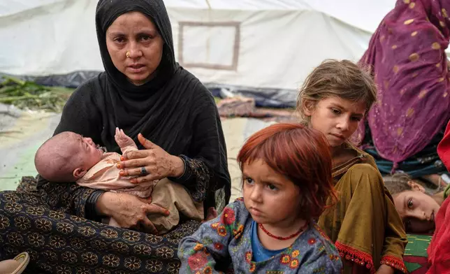 FILE - A woman and her children, survivors of Sunday night's 6.0-magnitude earthquake, wait for assistance in the village of Wadir, Kunar province, eastern Afghanistan, Tuesday, Sept. 2, 2025. (AP Photo/Nava Jamshidi, File)