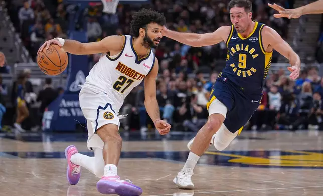 Denver Nuggets guard Jamal Murray (27) drives on Indiana Pacers guard T.J. McConnell (9) during the second half of an NBA basketball game in Indianapolis, Wednesday, Dec. 3, 2025. (AP Photo/Michael Conroy)