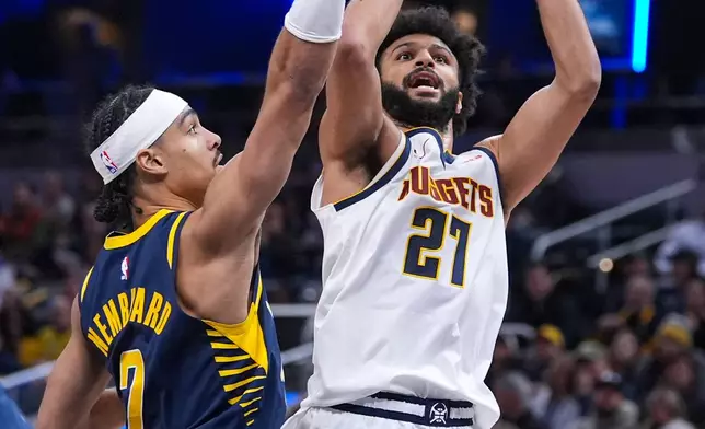 Denver Nuggets guard Jamal Murray (27) shoots over Indiana Pacers guard Andrew Nembhard (2) during the second half of an NBA basketball game in Indianapolis, Wednesday, Dec. 3, 2025. (AP Photo/Michael Conroy)