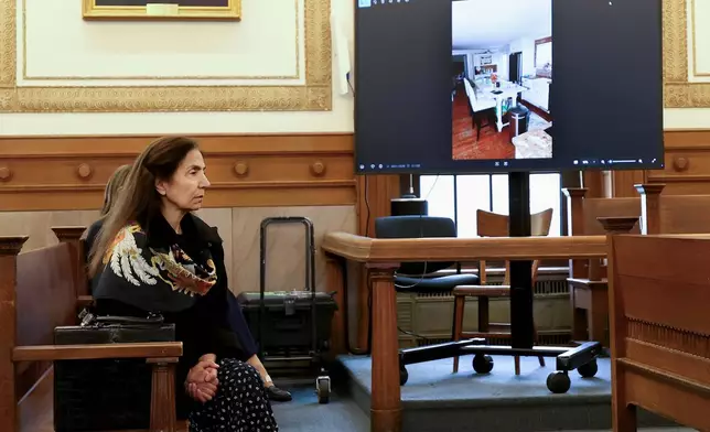 Diana Walshe listens to testimony as a photo of Brian Walshe's kitchen is projected on a monitor during his murder trial, Wednesday, Dec. 10, 2025, in Dedham, Mass. (Mark Stockwell/The Boston Herald via AP, Pool)