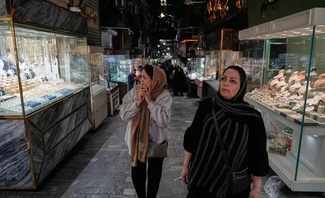 Women walk at a gold market in Tehran's Grand Bazaar, Iran, Saturday, Nov. 29, 2025. (AP Photo/Vahid Salemi)