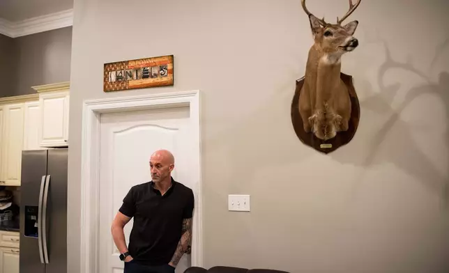 Joseph "Tucker" Daniels listens to lawyers at his home in Thibodaux, La., Thursday, Nov. 13, 2025, after speaking about his 13-year-old daughter being bullied with AI-generated deepfake pornographic images created of her by a boy classmate at Sixth Ward Middle School in August. (AP Photo/Matthew Hinton)