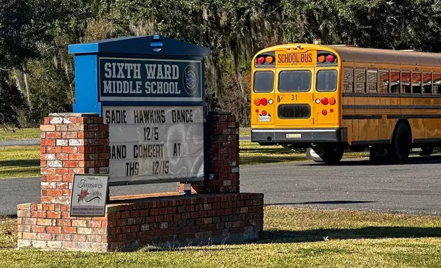 A school bus carries children at the end of a school day at Sixth Ward Middle School in Thibodaux, La., on Dec, 11, 2025. (AP Photo/Stephen Smith)