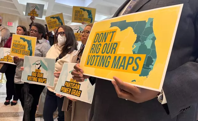 Opponents of mid-decade efforts to redraw congressional voting districts gather to protest in the Florida Capitol in Tallahassee, Fla., Dec. 2, 2025. (AP Photo/Kate Payne)