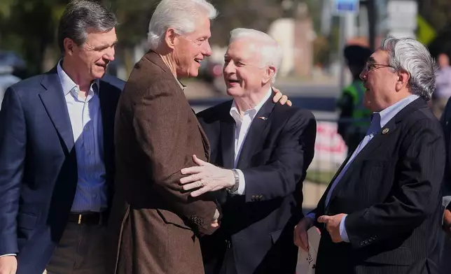 FILE - Former President Bill Clinton, second left, greets former North Carolina Gov. Jim Hunt, second right, U.S. Rep. G.K. Butterfield, D-1st District, right, and North Carolina Attorney General Roy Cooper, during a rally Oct. 25, 2016, while campaigning for Democratic presidental nominee Hillary Clinton at the N.C. Democratic Party Coordinated Campaign Office in Rocky Mount, N.C. (Alan Campbell/The Rocky Mount Telegram via AP, File)