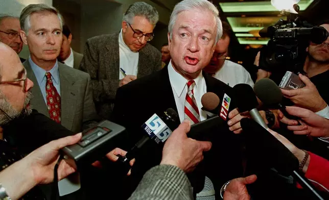 FILE - North Carolina Gov. Jim Hunt responds to reporters' questions at a hotel, in Durham, N.C., Jan. 20, 1999. (AP Photo/Bob Jordan, File)