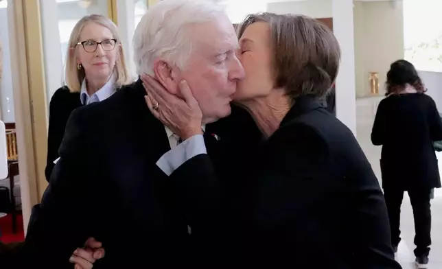 FILE - North Carolina Lt. Gov. Rachel Hunt, right, kisses her father, former North Carolina Gov. Jim Hunt, left, after she presided over the Senate session at the Legislative Building, Jan. 8, 2025, in Raleigh, N.C. (AP Photo/Chris Seward, File)