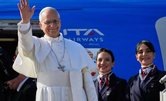 Pope Leo XIV waves as he boards a flight back to the Vatican after his visit to Lebanon at Beirut International Airport in Beirut, Lebanon, Tuesday, Dec. 2, 2025. (AP Photo/Hussein Malla)