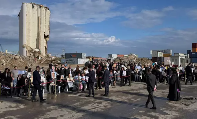 Relatives of victims of the 2020 Beirut port explosion wait for the arrival of Pope Leo XIV at the site off the explosion in Beirut, Lebanon, Tuesday, Dec. 2, 2025. (AP Photo/Fadi Tawil)