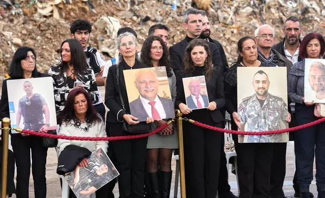 Relatives of victims of the 2020 Beirut port explosion wait for the arrival of Pope Leo XIV at the site of the explosion in Beirut, Lebanon, Tuesday, Dec. 2, 2025. (AP Photo/Domenico Stinellis)