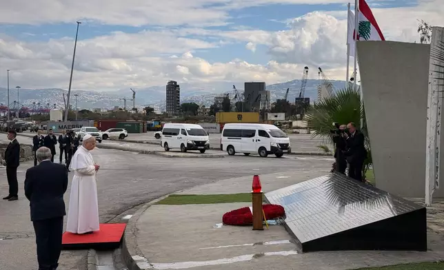 Pope Leo XIV prays at a memorial for the victims of the 2020 Beirut port explosion at the site off the explosion in Beirut, Lebanon, Tuesday, Dec. 2, 2025. (AP Photo/Fadi Tawil)