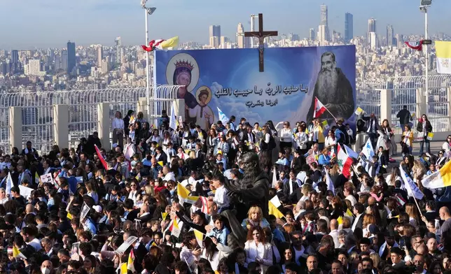 People wait for the arrival of Pope Leo XIV to visit the De la Croix hospital in Jal el Dib, Lebanon, Tuesday, Dec. 2, 2025. (AP Photo/Domenico Stinellis)
