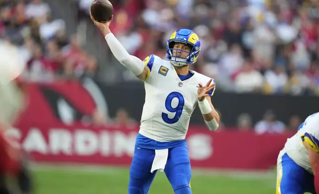 Los Angeles Rams quarterback Matthew Stafford passes the ball in the first half of an NFL football game against the Arizona Cardinals, Sunday, Dec. 7, 2025, in Glendale, Ariz. (AP Photo/Ross D. Franklin)