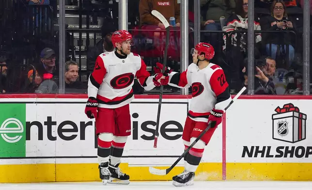 Carolina Hurricanes' Nikolaj Ehlers, left, celebrates his goal with Logan Stankoven (22) during the second period of an NHL hockey game Philadelphia Flyers, Saturday, Dec. 13, 2025, in Philadelphia. (AP Photo/Derik Hamilton)