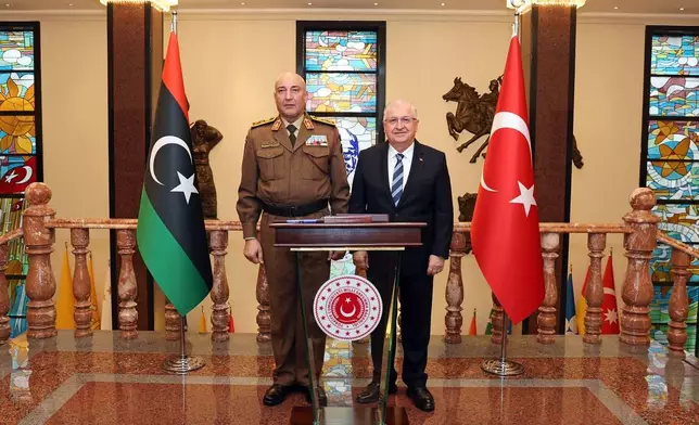 In this photo released by the Turkish Defense Ministry, Turkey's Chief of General Staff Gen. Selcuk Bayraktaroglu, right, poses for a photograph with Libyan Chief of General Staff Gen. Mohamed Ali Ahmed El Haddad during their meeting in Ankara, Turkey, Tuesday, Dec. 23, 2025. (Turkish Defense Ministry via AP)