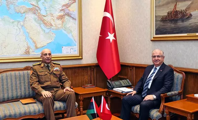 In this photo released by the Turkish Defense Ministry, Turkey's Chief of General Staff Gen. Selcuk Bayraktaroglu, right, poses for a photograph with Libyan Chief of General Staff Gen. Mohamed Ali Ahmed El Haddad during their meeting in Ankara, Turkey, Tuesday, Dec. 23, 2025. (Turkish Defense Ministry via AP)