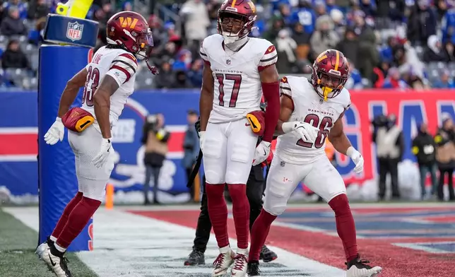 Washington Commanders wide receiver Terry McLaurin (17) celebrates with teammates after scoring a touchdown against the New York Giants during the fourth quarter of an NFL football game, Sunday, Dec. 14, 2025, in East Rutherford, N.J. (AP Photo/Yuki Iwamura)