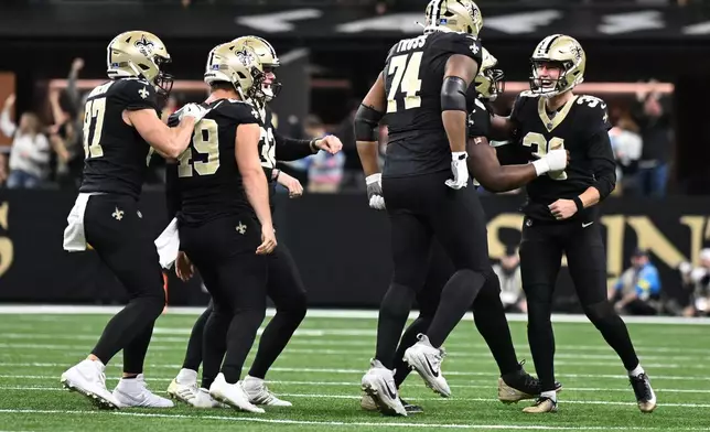 New Orleans Saints place-kicker Charlie Smyth (39) and teammates celebrate after field goal in the second half of an NFL football game against the Carolina Panthers, Sunday, Dec. 14, 2025, in New Orleans. (AP Photo/Ella Hall)