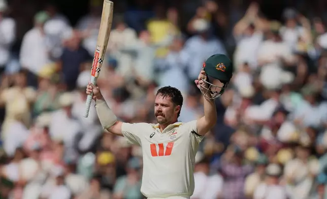 Australia's Travis Head celebrates after scoring century during play on day three of the third Ashes cricket test between England and Australia in Adelaide, Australia, Friday, Dec. 19, 2025. (AP Photo/James Elsby)