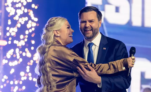 Erika Kirk greets Vice President JD Vance during Turning Point USA's AmericaFest 2025, Sunday, Dec. 21, 2025, in Phoenix. (AP Photo/Jon Cherry)