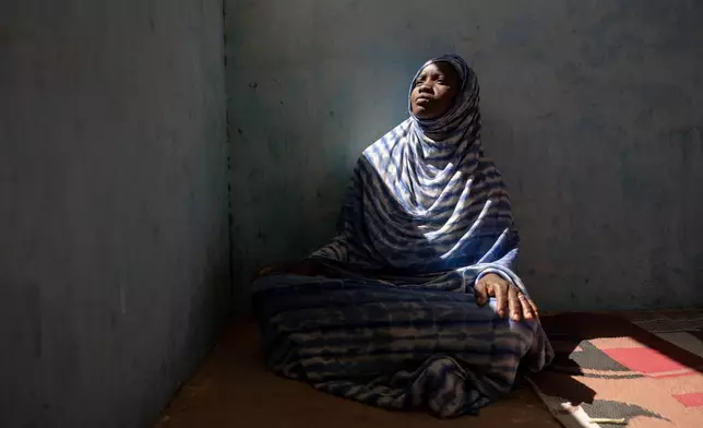 Moyme, who fled Mali in fear of the Malian Army and its Russian allies, poses for a portrait in the Mbera camp, Mauritania, where she found refuge, Nov. 4, 2025. (AP Photo/Caitlin Kelly)