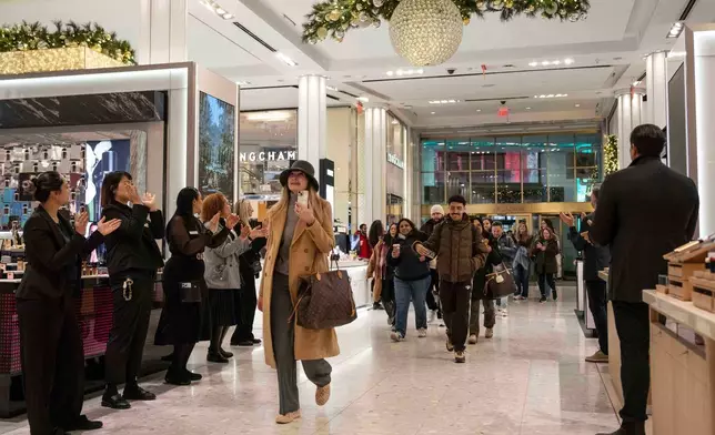 Customers walk into Macy's flagship store, Friday, Nov. 21, 2025, in New York. (AP Photo/Yuki Iwamura)