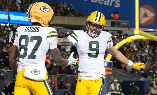 Green Bay Packers' Romeo Doubs celebrates his touchdown catch with Christian Watson during the second half of an NFL football game against the Chicago Bears Saturday, Dec. 20, 2025, in Chicago. (AP Photo/Nam Huh)