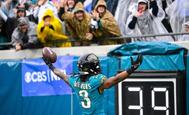 Jacksonville Jaguars wide receiver Jakobi Meyers (3) celebrates a touchdown against the Indianapolis Colts during the first half of an NFL football game, Sunday, Dec. 7, 2025, in Jacksonville, Fla. (AP Photo/Phelan M. Ebenhack)