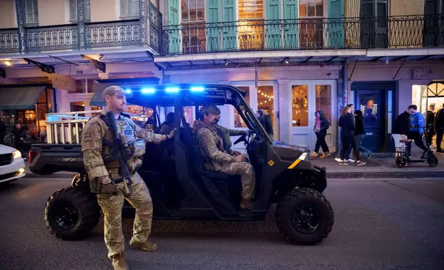 The Louisiana National Guard, military police, and Louisiana law enforcement agencies patrol the French Quarter along Royal Street as part of a National Guard deployment for New Year's celebrations in New Orleans, Tuesday, Dec. 30, 2025. (AP Photo/Matthew Hinton)